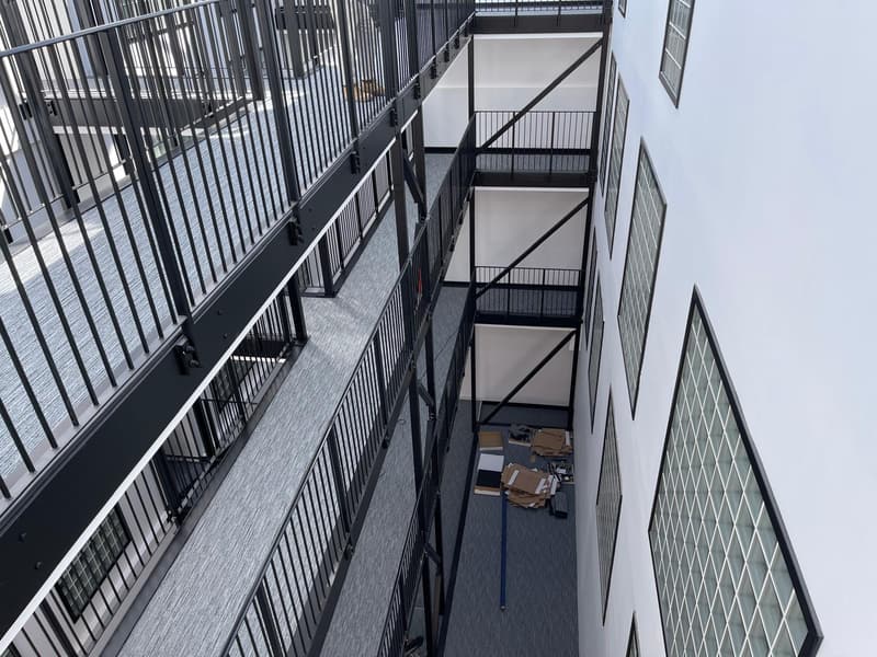 Steel walkways beside the glass-block wall