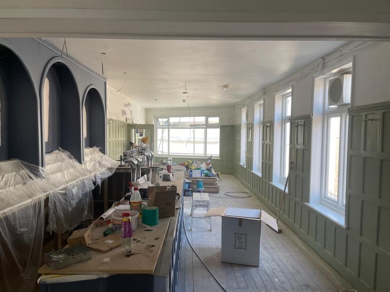 Sage green panelled walls along the room