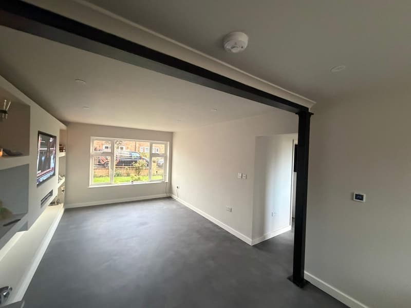 After: smooth walls, painted media wall and a black beam