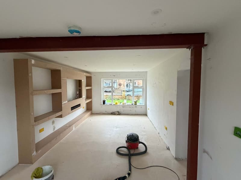 Before: bare plaster, raw MDF and a primer-red beam
