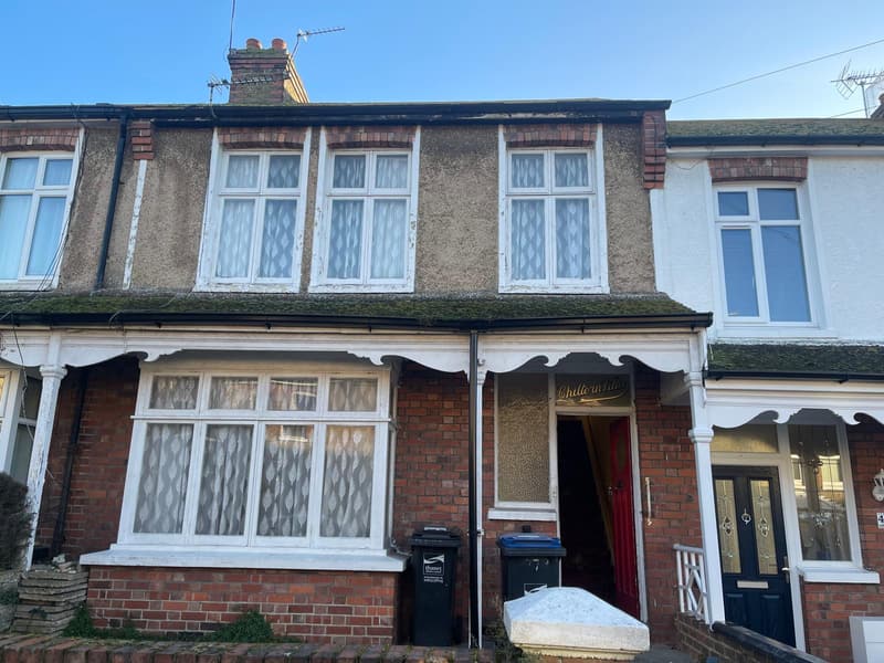 Before: brown pebbledash and a red front door