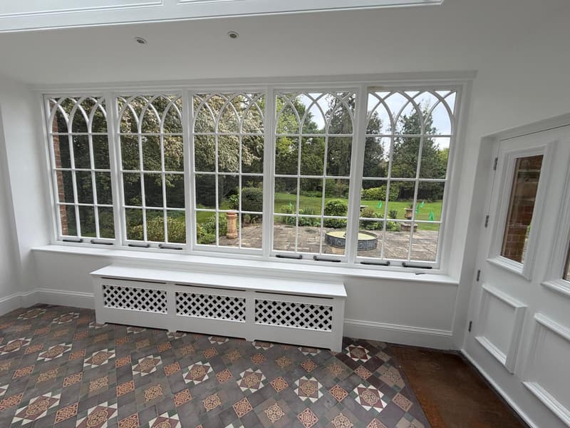 Arched windows and radiator cover in white